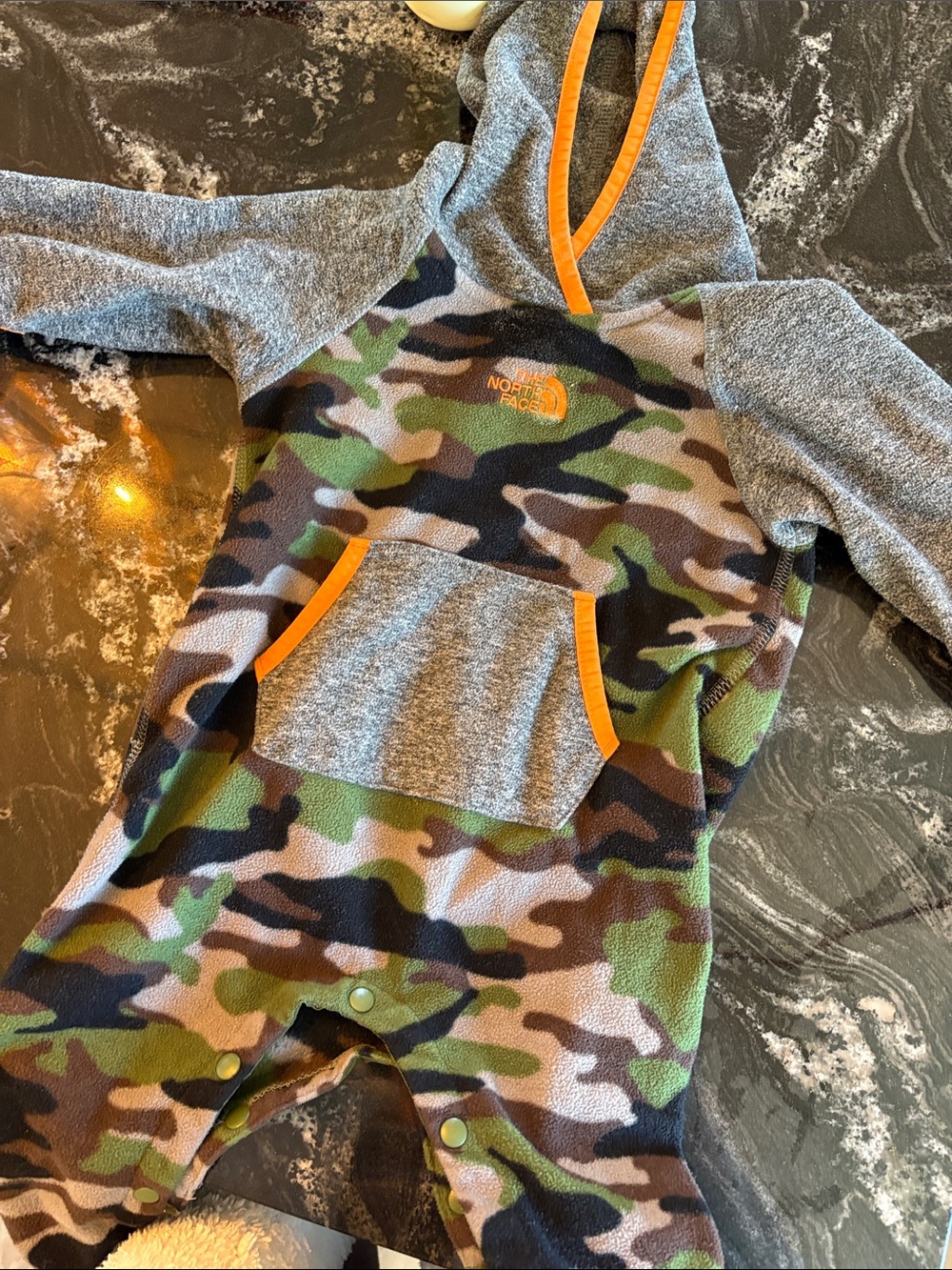 The North Face Camo Fleece Hooded Romper with Gray Sleeves and Orange Trim